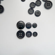 Load image into Gallery viewer, 4-hole corozo buttons shown in three different sizes, one side shows a smooth domed side, the other shows a flat with edged rim