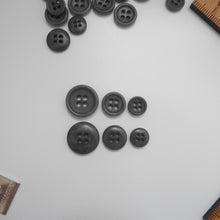 Load image into Gallery viewer, 4-hole corozo buttons shown in three different sizes, one side shows a smooth domed side, the other shows a flat with edged rim