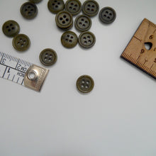 Load image into Gallery viewer, Corozo button with 4 holes, displayed amongst tape measure and ruler