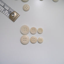Load image into Gallery viewer, 4-hole corozo buttons shown in three different sizes, one side shows a smooth domed side, the other shows a flat with edged rim