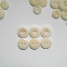 Load image into Gallery viewer, Larger 2-hole corozo buttons shows the smooth side and the concave side