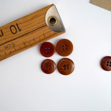 Load image into Gallery viewer, Four 4-hole buttons in 2 different sizes, shows one flat side, and one domed side