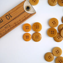 Load image into Gallery viewer, Four 4-hole buttons in 2 different sizes, shows one flat side, and one domed side