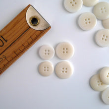 Load image into Gallery viewer, Four 4-hole buttons in 2 different sizes, shows one flat side, and one domed side