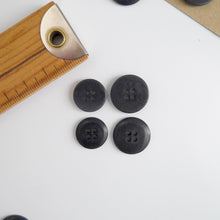 Load image into Gallery viewer, Four 4-hole buttons in 2 different sizes, shows one flat side, and one domed side