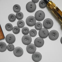 Load image into Gallery viewer, A scatter of 2-hole corozo buttons in two different sizes