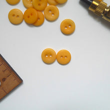 Load image into Gallery viewer, Two 2-hole corozo buttons, one shows the smooth dome side, the other shows the concaved side