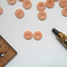 Load image into Gallery viewer, Two 2-hole corozo buttons, one showing a smooth dome side, one showing the concaved side