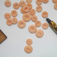 Load image into Gallery viewer, A scattering of 2-hole corozo buttons in two sizes