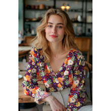 Load image into Gallery viewer, Model wears a wrap over blouse made with floral eco Viscose fabric