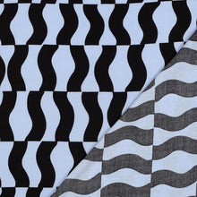 Load image into Gallery viewer, Eco Viscose fabric displayed with its reverse side (with faint print) lain atop