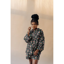 Load image into Gallery viewer, Model wears a button up shirt and shorts co-ord, made with the Flowers Eco Viscose Fabric