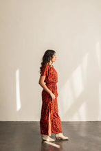 Load image into Gallery viewer, Side view of lady wearing Avenir Jumpsuit with short sleeves