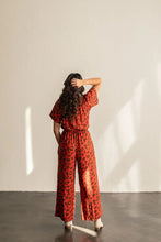 Load image into Gallery viewer, Back view of lady wearing Avenir Jumpsuit with short sleeves