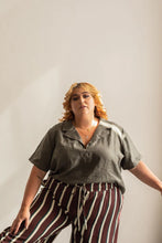 Load image into Gallery viewer, Lady stands wearing a short sleeve open collar Donny shirt