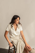 Load image into Gallery viewer, Lady seated wearing a short sleeved deep V neck open collar Donny shirt