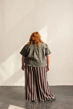 Load image into Gallery viewer, Back view of lady standing wearing a short sleeve Donny shirt