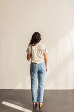 Load image into Gallery viewer, Back view of lady standing wearing a short sleeve Donny shirt