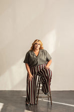 Load image into Gallery viewer, Lady sits wearing a deep V-neck open collar short sleeve Donny shirt