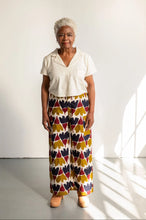 Load image into Gallery viewer, Model stands wearing wide-leg trouser with a busy print fabric