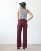 Load image into Gallery viewer, Back view of lady wearing Lander Pants, high waisted with belt loops, and rectangular patch pockets at hips