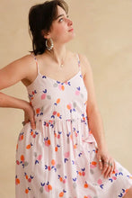 Load image into Gallery viewer, Lady wears a strappy v-neck dress made up in Limonade Viscose fabric