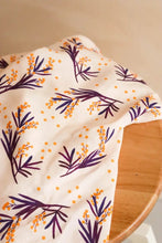 Load image into Gallery viewer, Mimosa Viscose fabric with sprigs print lays on wooden table
