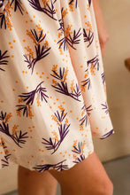 Load image into Gallery viewer, Close up of flowy knee-length skirt on dress made up in Mimosa viscose fabric