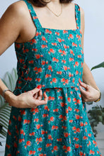 Load image into Gallery viewer, Close up of lady holding down her bodice made up with the Evergreen viscose fabric