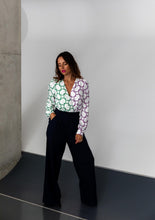 Load image into Gallery viewer, Lady wears Brooklyn Trousers: wide legged trousers with pleats at waist, hand in pocket
