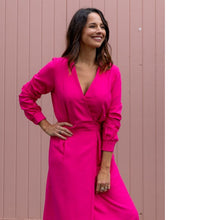Load image into Gallery viewer, Lady wears a long sleeved wrap dress