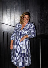 Load image into Gallery viewer, Lady wears a long sleeved wrap dress in a geometric fabric pattern print