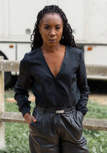 Load image into Gallery viewer, Lady wears a long sleeved wrap blouse tucked into trousers