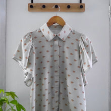Load image into Gallery viewer, Collared shirt with short flutter sleeves made with Tranquil EcoVero Viscose fabric hangs on hanger