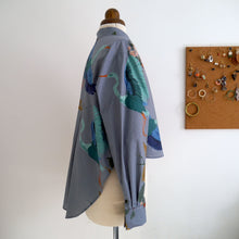 Load image into Gallery viewer, Side view of Heron-Heights Cotton fabric shirt on a mannequin, long sleeve with cuff, with cropped hem at front, longer scoop hem at back