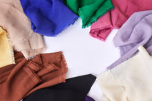 Load image into Gallery viewer, Selvedge ends of Vida Voile fabrics in various colours displayed in a circle