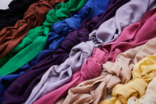 Load image into Gallery viewer, Various colour versions of Vida Voile Fabrics lay next to each other with knot to show fluid drape of fabric