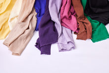 Load image into Gallery viewer, Selvedge edges of various colourways of Vida Voile Fabric lay next to each other