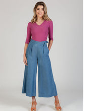 Load image into Gallery viewer, Lady wears a pair cropped wide-leg trousers with pleats at waist, hand in side seam pocket
