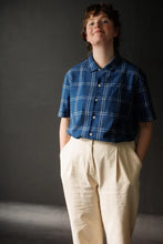 Load image into Gallery viewer, Model stands wearing short sleeve, button-up shirt, fastened to the neck