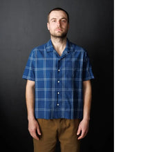 Load image into Gallery viewer, Model stands wearing short sleeve, button-up shirt with open collar.