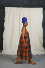 Load image into Gallery viewer, Side view of model wearing the Honey Dress: a sleeveless dress gathered at bust.