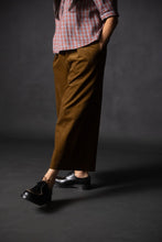Load image into Gallery viewer, Model in motion taking a step, wearing Juno wide-leg culotte trousers