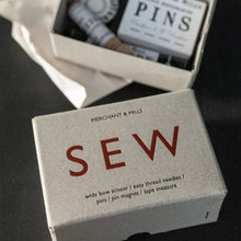 Load image into Gallery viewer, Cardboard box with "sew" printed on, next to box of various haberdashery tools