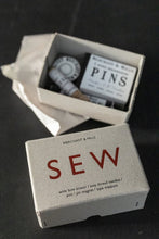 Load image into Gallery viewer, Cardboard box with "sew" printed on, next to box of various haberdashery tools