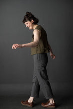 Load image into Gallery viewer, Lady mid walk wears cropped tapered trousers in a stripe pattern fabric