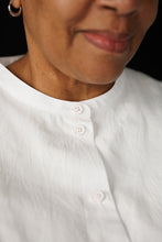 Load image into Gallery viewer, Close up detail of fastened up button shirt with grandad collar