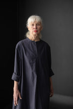 Load image into Gallery viewer, Lady wears a shirtdress with bibbed front and grandad collar, rolled up sleeves