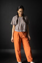 Load image into Gallery viewer, Lady wears peg trousers with front pleats and fly with turn ups
