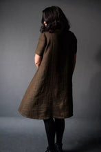 Load image into Gallery viewer, Back view of model wearing short sleeved version of the Trapeze dress, flare shown